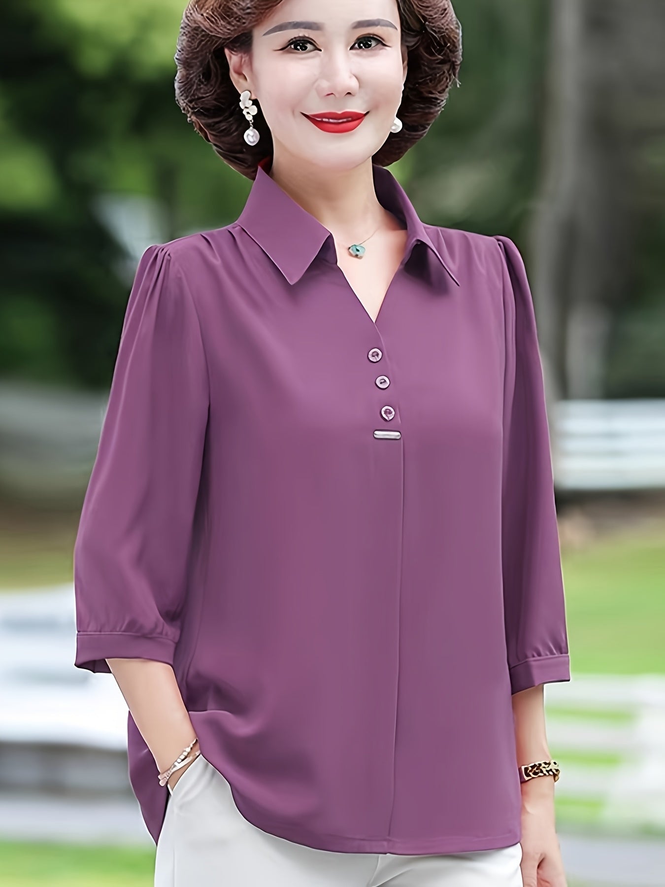 Stylish purple chiffon blouse for women with 3/4 sleeves, slimming fit, and decorative buttons. Made of lightweight polyester-elastane blend, perfect for spring, summer, and fall. Features