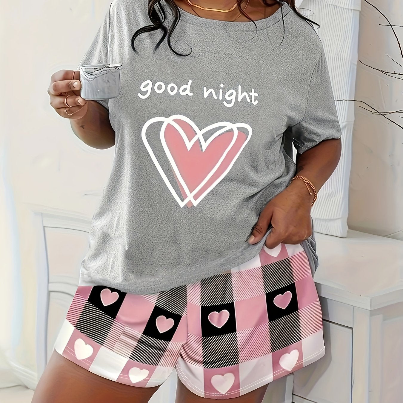 Plus size pajama set for women featuring a cute cartoon heart and leopard print design. Made from 95% polyester and 5% elastane knit fabric, with a slight stretch and crew neck. Suitable