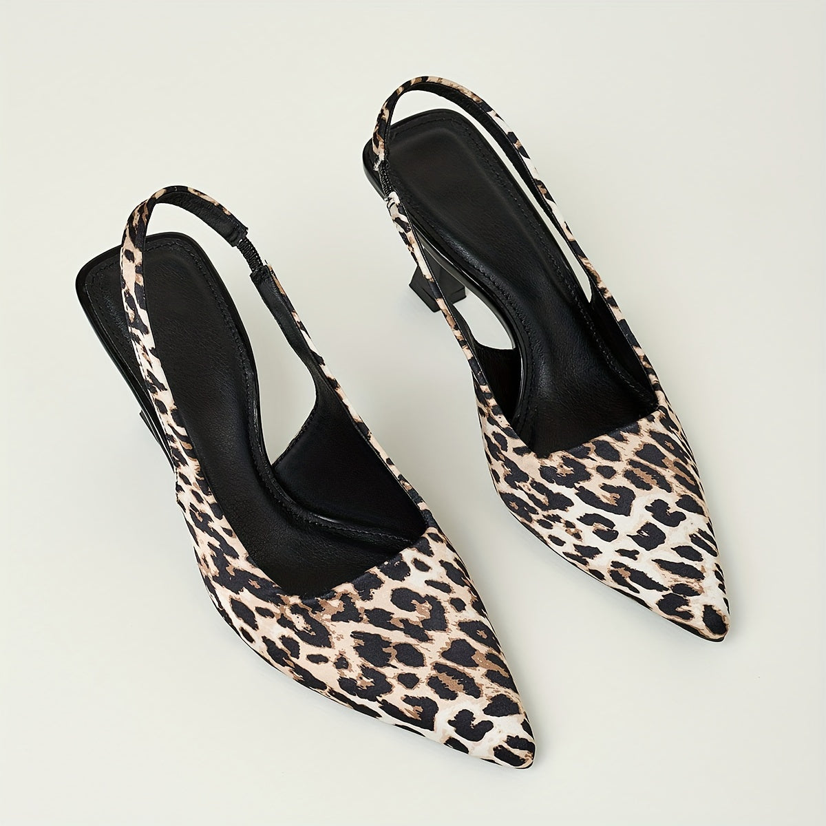 Leopard print stiletto sandals with pointed toe, slip-on style, and high heels in black and brown animal pattern. Comfortable for fall fashion.