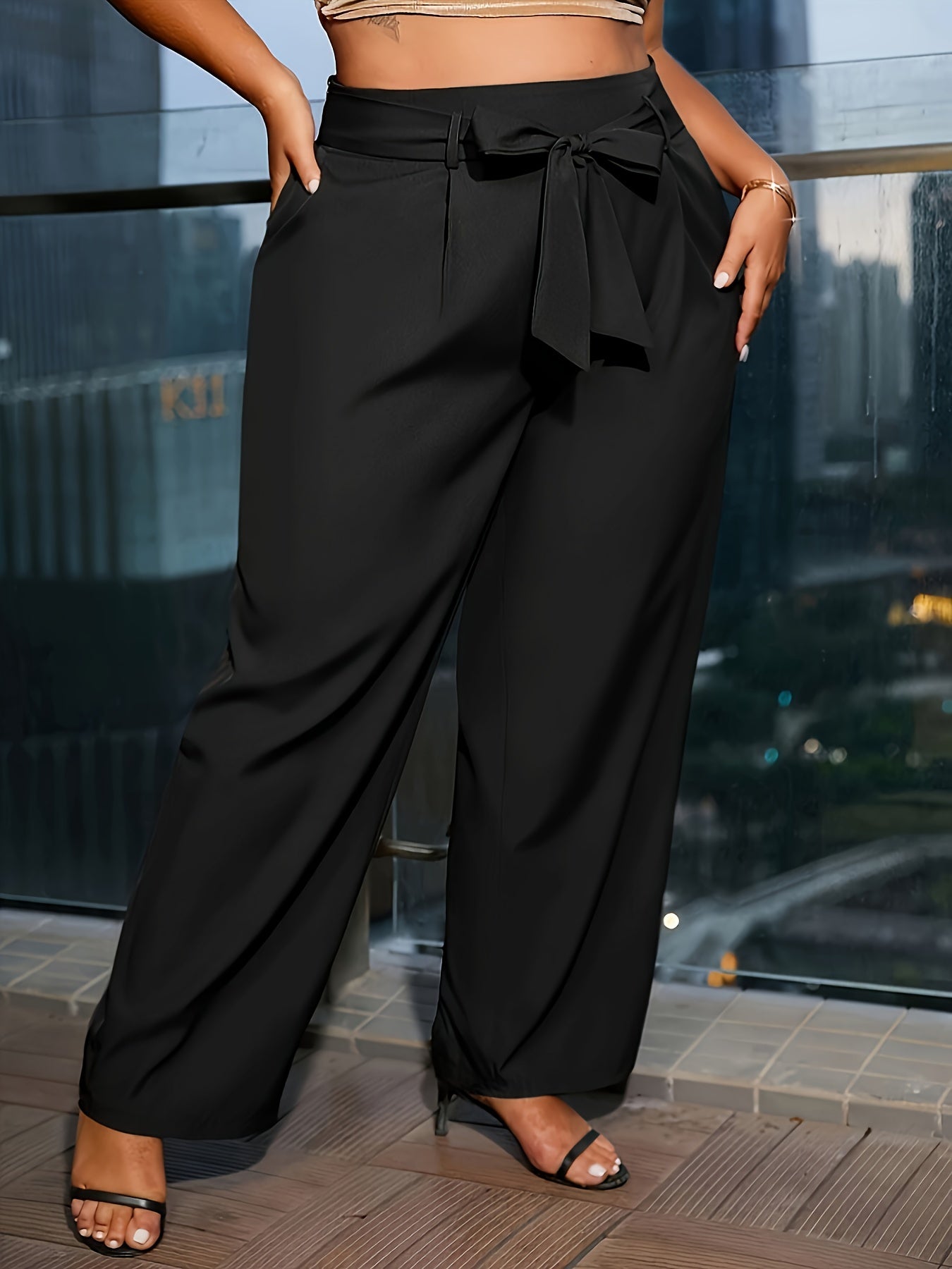 Solid wide leg pants suitable for plus size women in spring and fall with pockets and tie front detail.