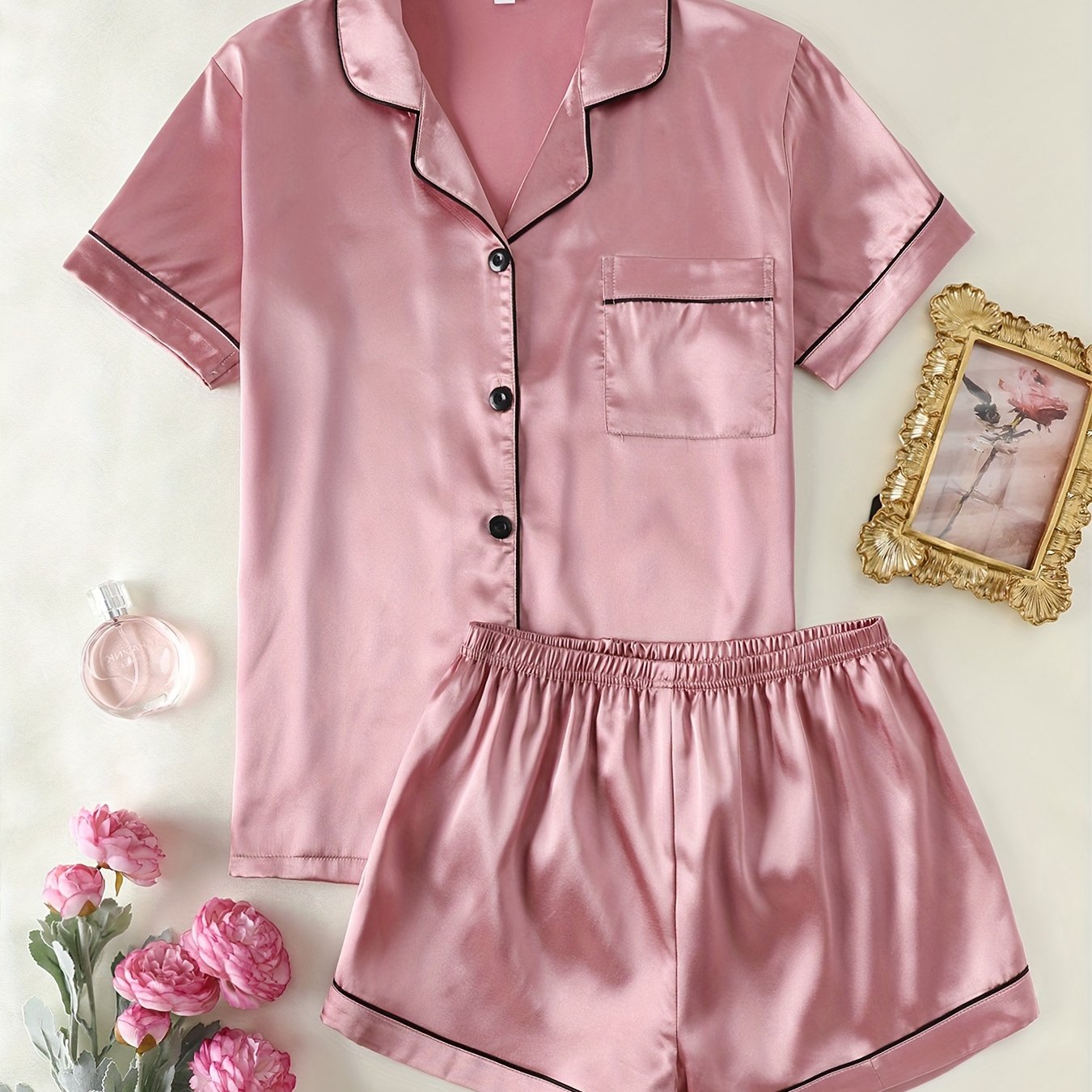 Satin lounge set includes a short sleeve button-up top with lapel collar and elastic shorts.