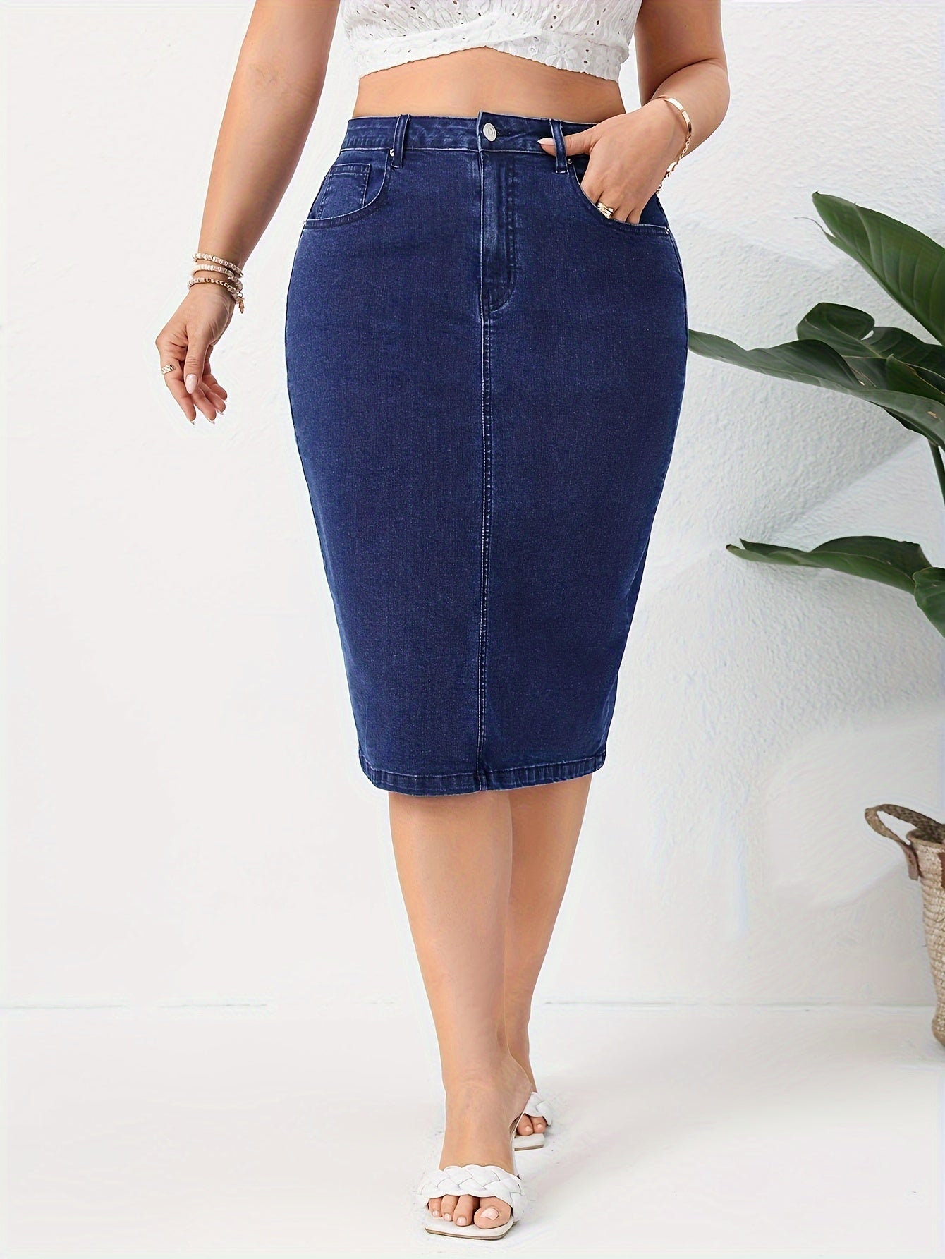 Blue washed high rise plus size bodycon denim skirt with slash pockets for women.