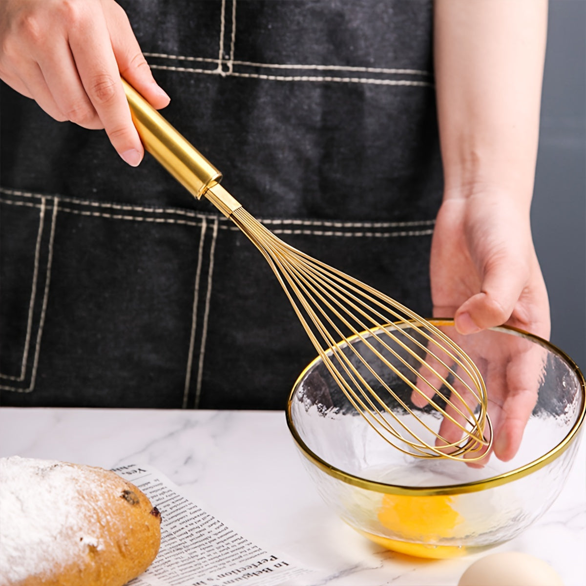 Golden Stainless Steel Egg Whisk is a versatile baking tool that is perfect for cooking in nonstick cookware. This heat-resistant kitchen whisk can be used for mixing, whirling, foaming, and stirring food.