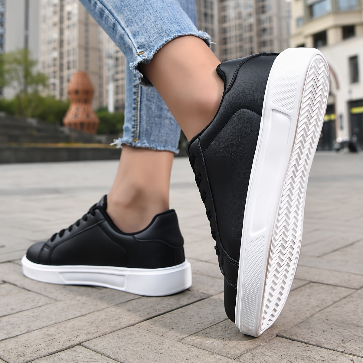 Black lace-up sneakers for women, versatile and comfortable for outdoor activities.