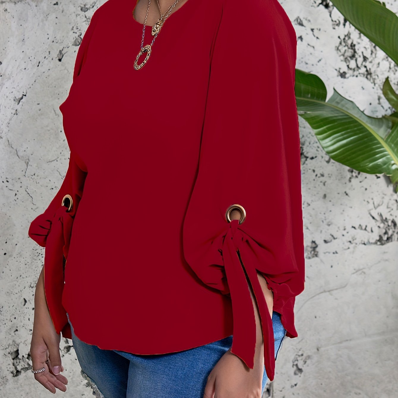 Plus size women's casual top with solid colors, lantern sleeves, round neck, round hem, and knot detail.