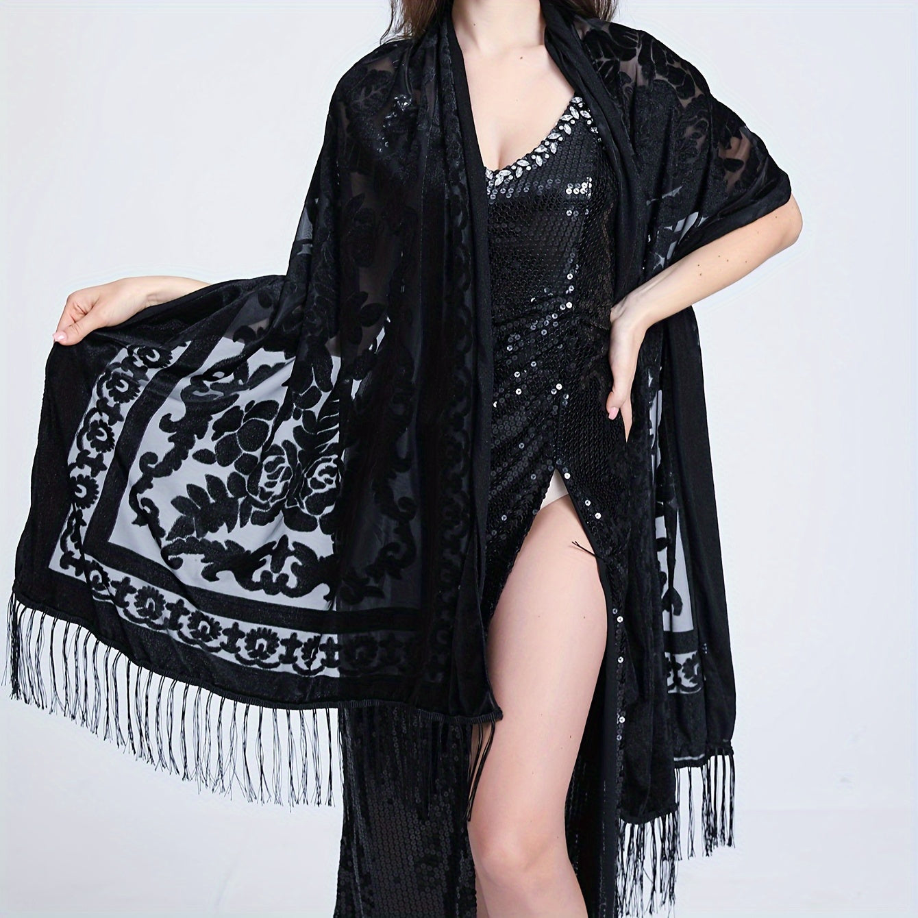 Black floral lace shawl with tassels featuring an elegant rose pattern, 3D carved design, and made of hand washable polyester. Perfect for evening events and dates.