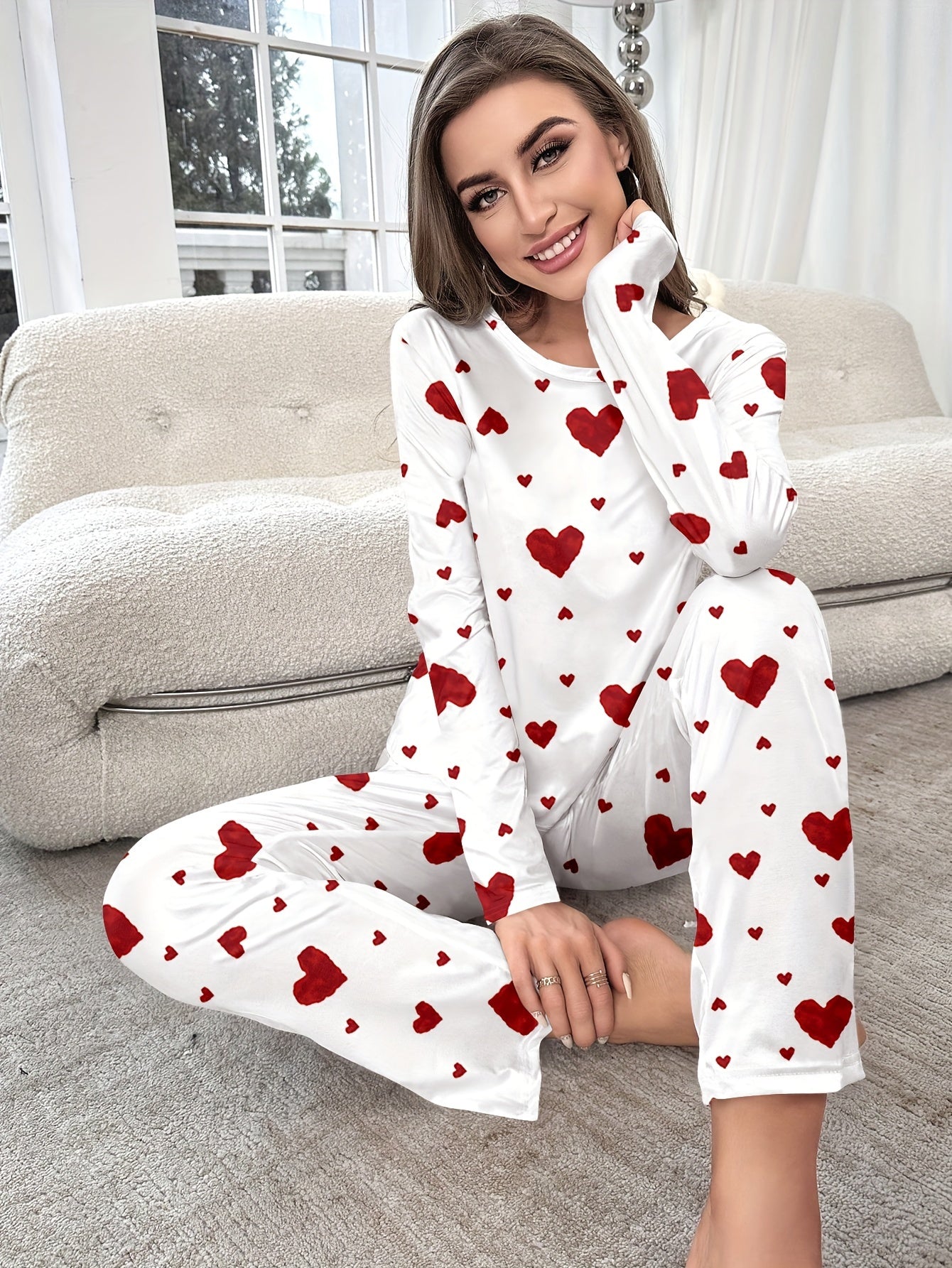 Women's heart print pajama set with round neck and long sleeves. Made from polyester, perfect for cozy home wear in autumn/winter. Includes long pants and pullover.