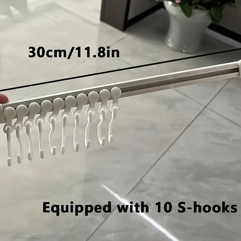 Kitchen storage rack with sliding hooks for easy installation, no drilling necessary; adhesive backing for convenient organization and utility hooks.