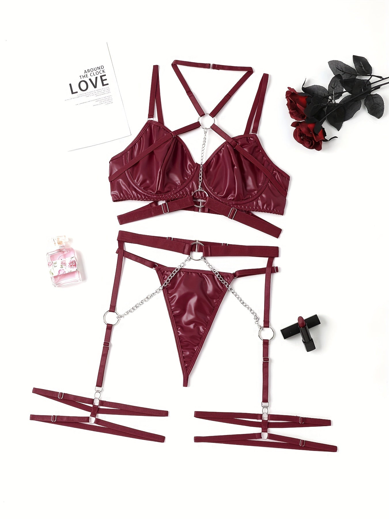 Women's punk lingerie set with ring-link strappy design, halter plunge bra, garter belt, and thong.