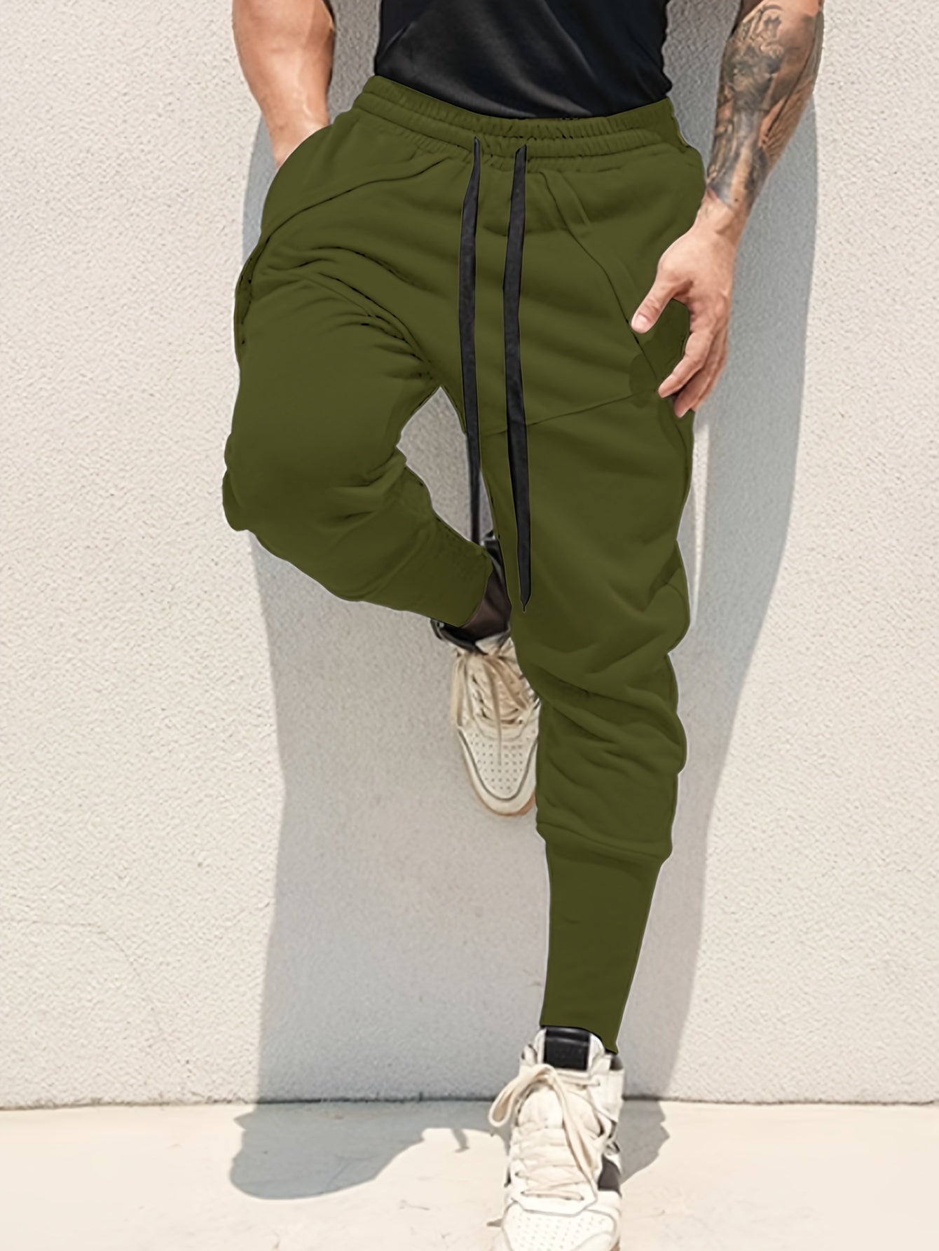 Casual style men's athletic sweatpants with tapered fit, side pockets, and adjustable drawstring for sports and relaxation.