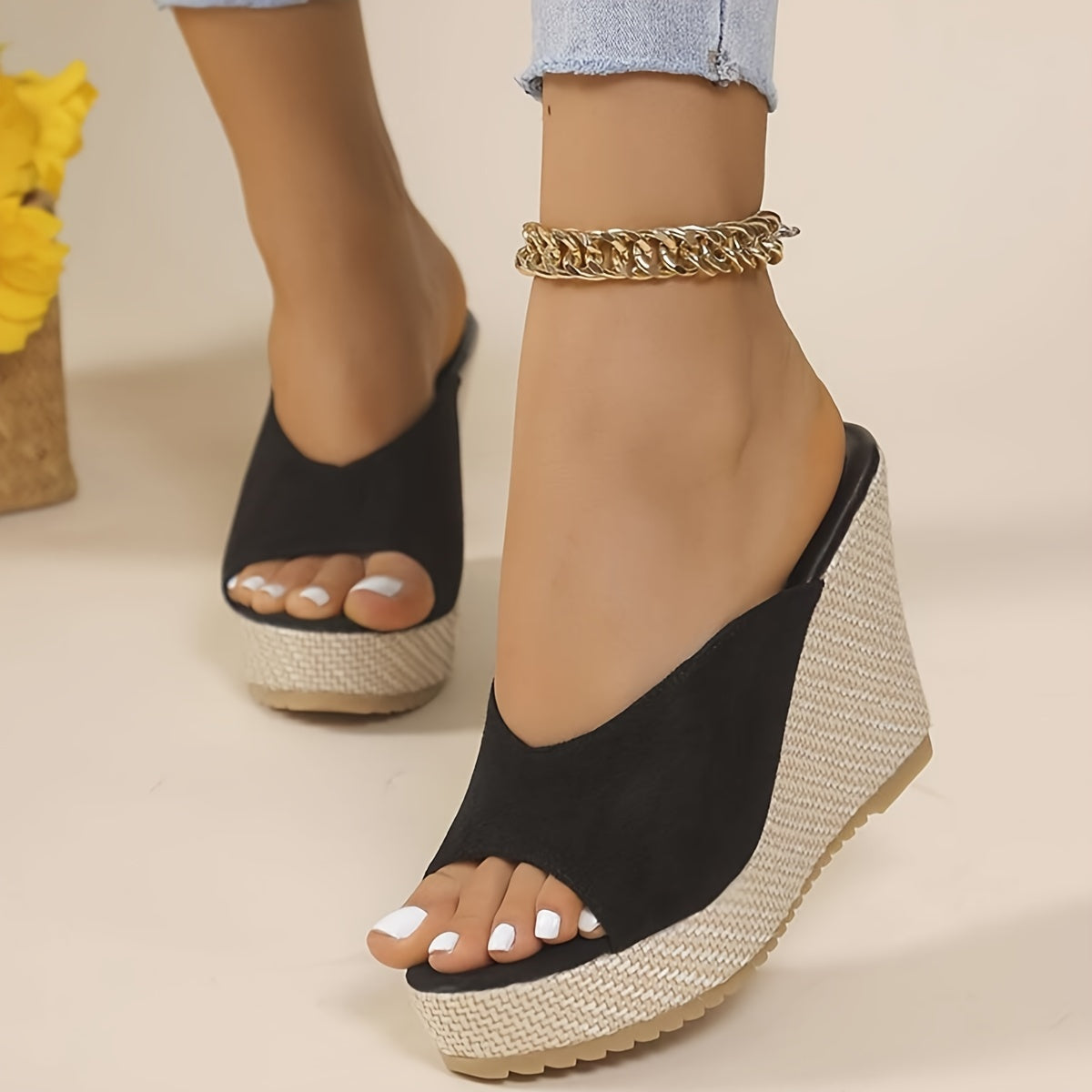 Black slip-on wedge sandals for women with an open toe, high heel, comfortable ankle strap, and woven design sole - perfect for casual summer wear.