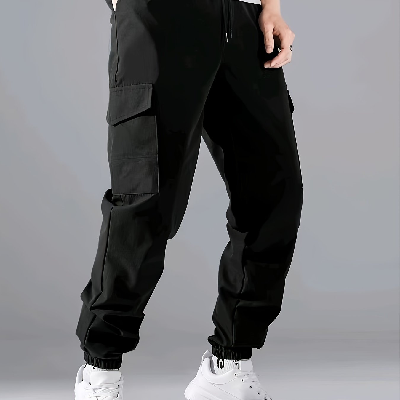 Men's casual joggers made of 100% polyester with a solid color, all-season, non-stretch fabric in a regular fit with pockets.