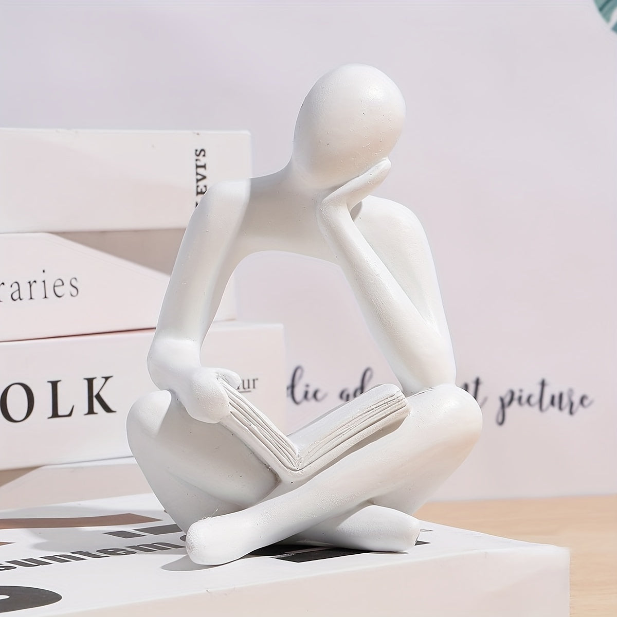 Abstract figure reading book with one hand ornament.