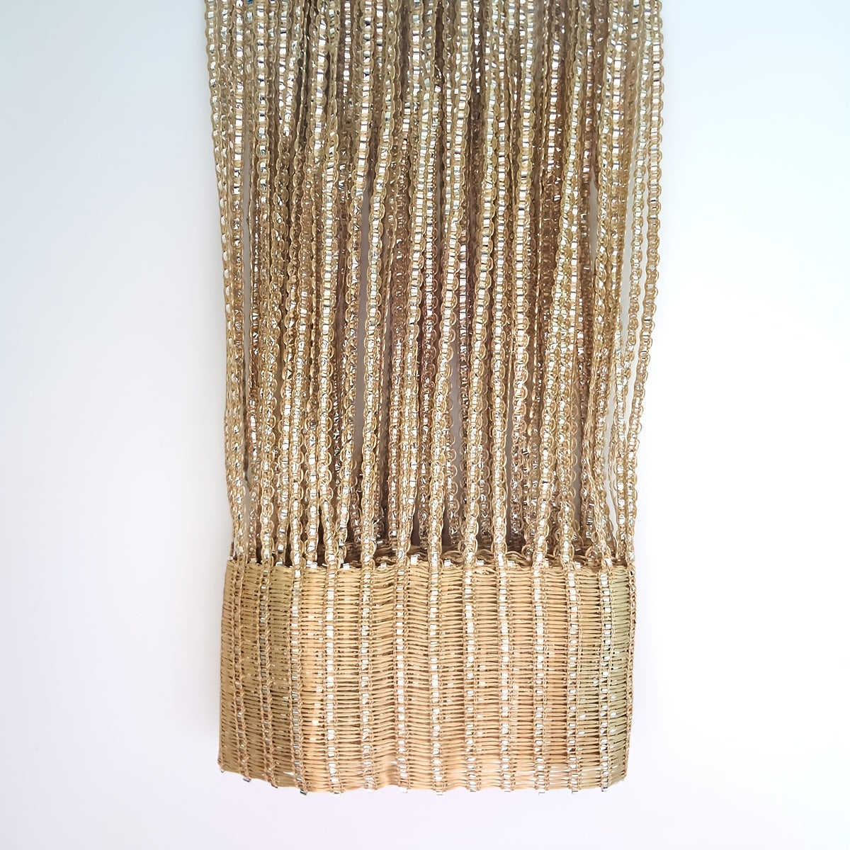 Shiny silver wire curtain with thick tassels, perfect for window or door decoration at weddings.