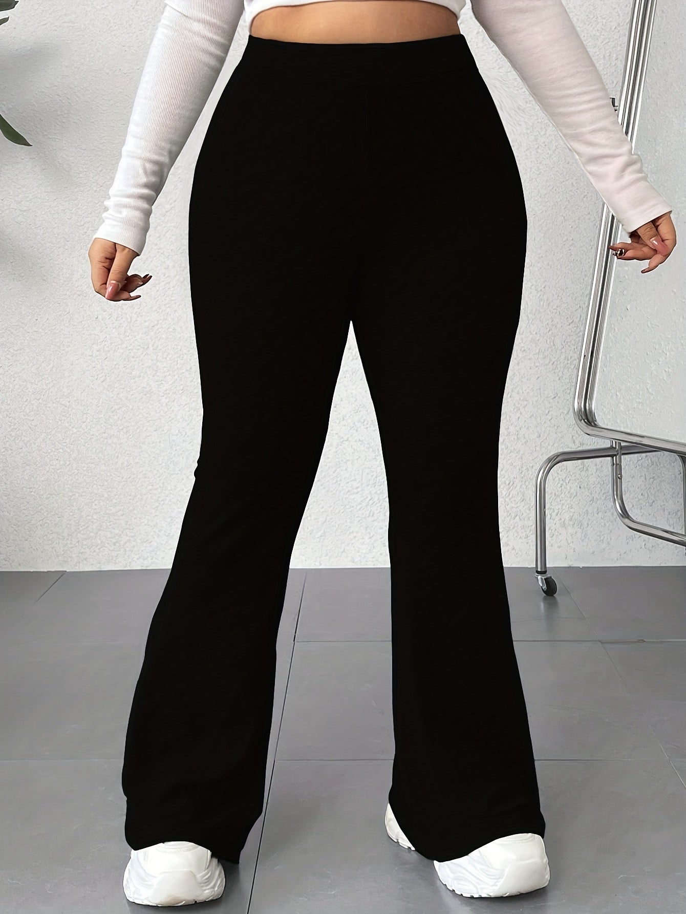 Solid color flared leg pants with a high waist, perfect for spring and summer in plus size women's clothing.