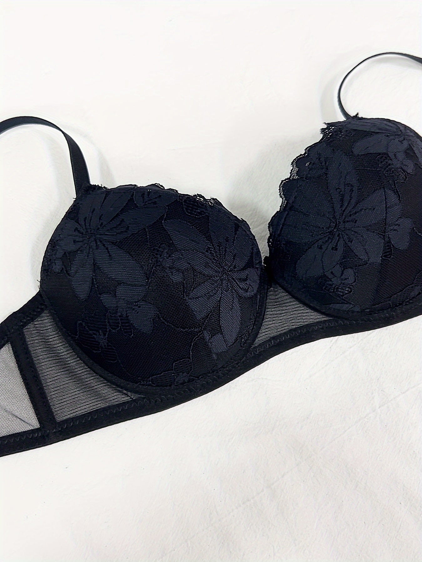 Floral embroidered lingerie set for women featuring a comfortable push-up bra, low-rise thong, mesh detail, and sexy triangle pant. Made with a nylon blend for breathability.