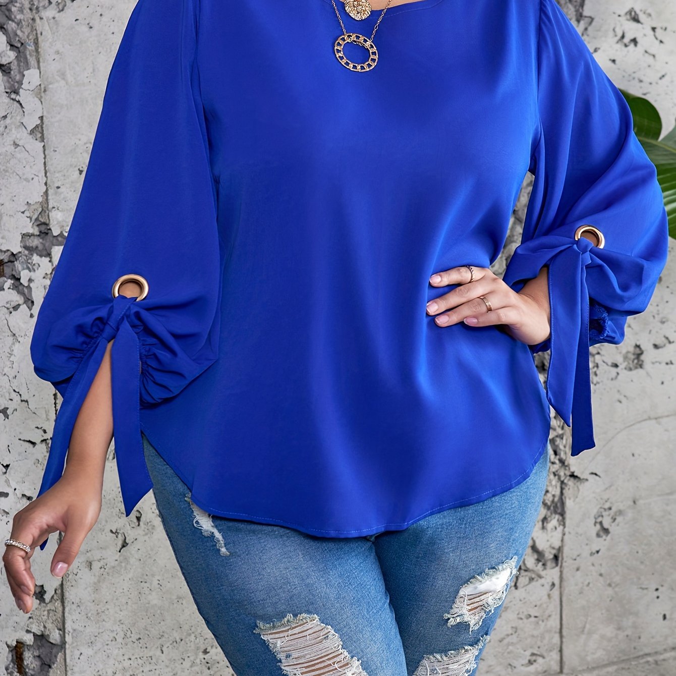 Plus size women's casual top with solid colors, lantern sleeves, round neck, round hem, and knot detail.