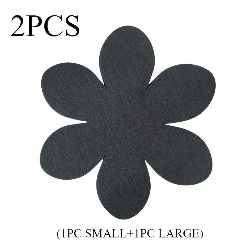 Set of 4 black petal-shaped pan pads made of non-woven, non-stick material. These pads are non-slip, anti-scalding, and provide heat insulation. They are easy to clean and made of multi-ply felt cloth.