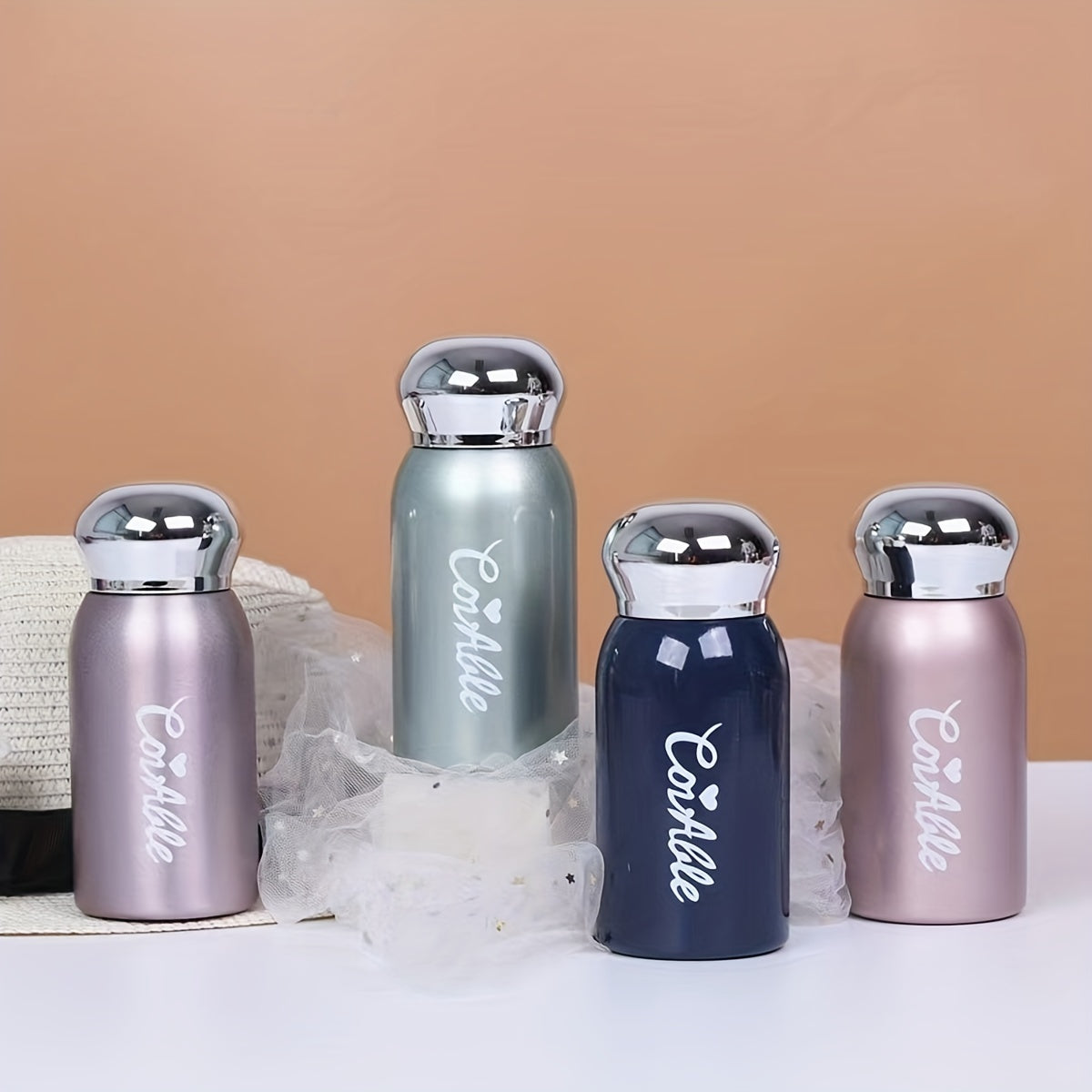 Small stainless steel vacuum flask with electroplated lid for on-the-go hydration. Ideal for students.