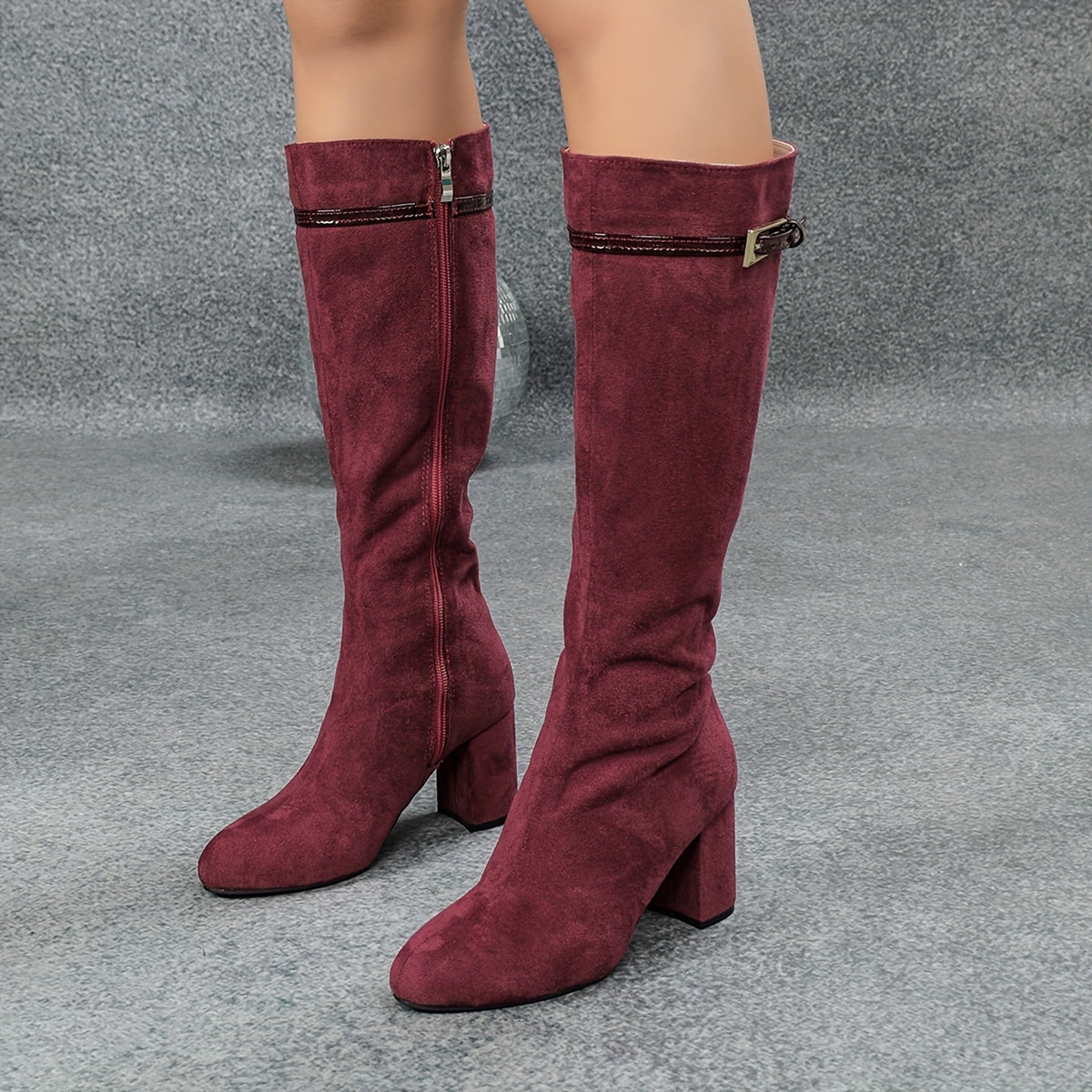 Burgundy side zip round toe knee-high boots with chunky heels.