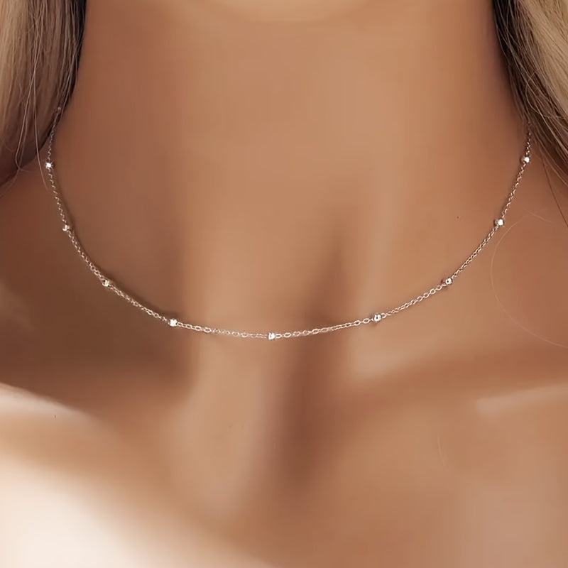 An elegant 925 silver necklace featuring 2 grams of shimmering beads, a delicate collarbone chain, and a stylish piece of jewelry designed for women.