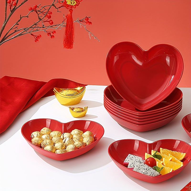 Heart-shaped plastic serving saucers in red for special occasions.