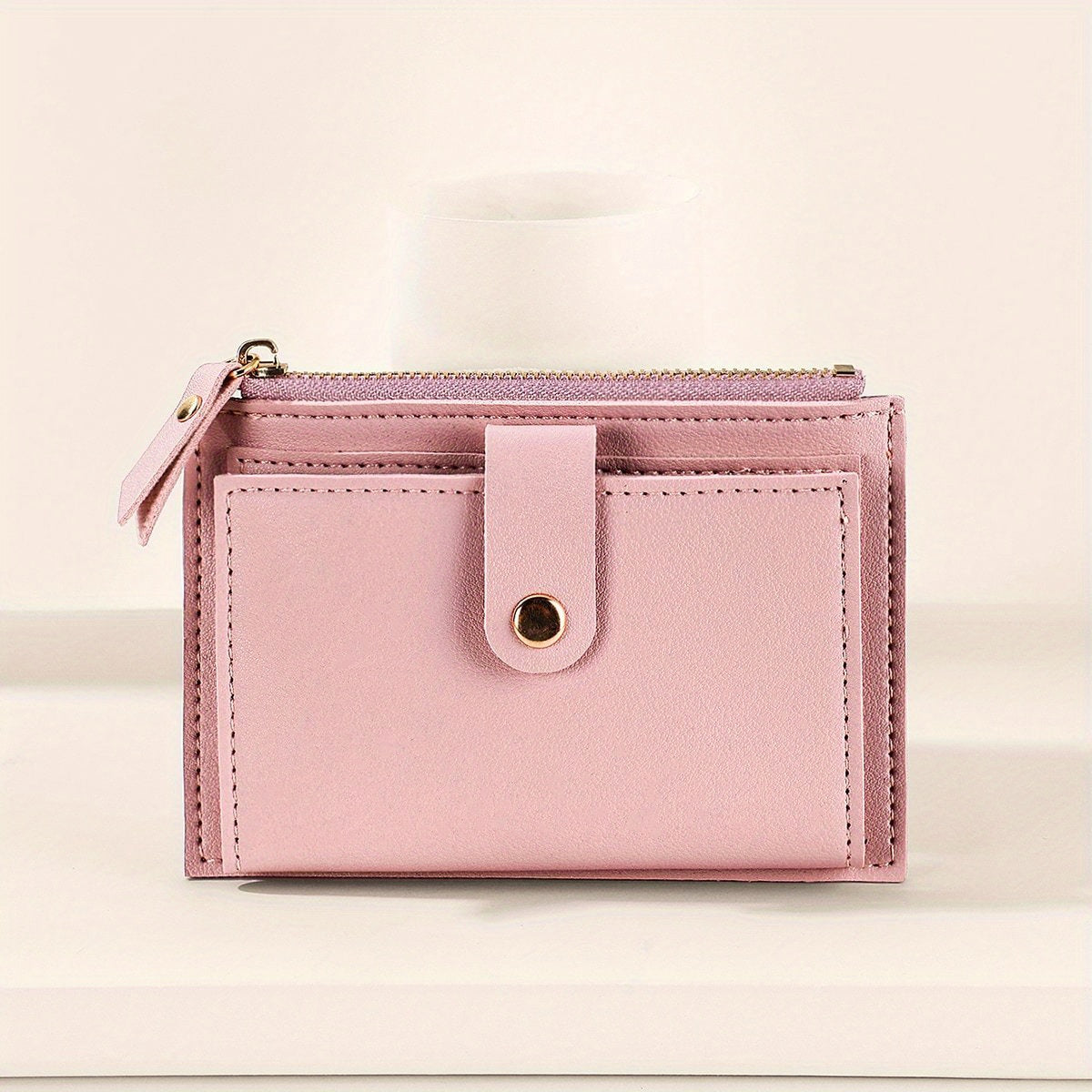 Slim short wallet for women with zipper closure, bifold design, credit card slots, coin purse, and solid color.