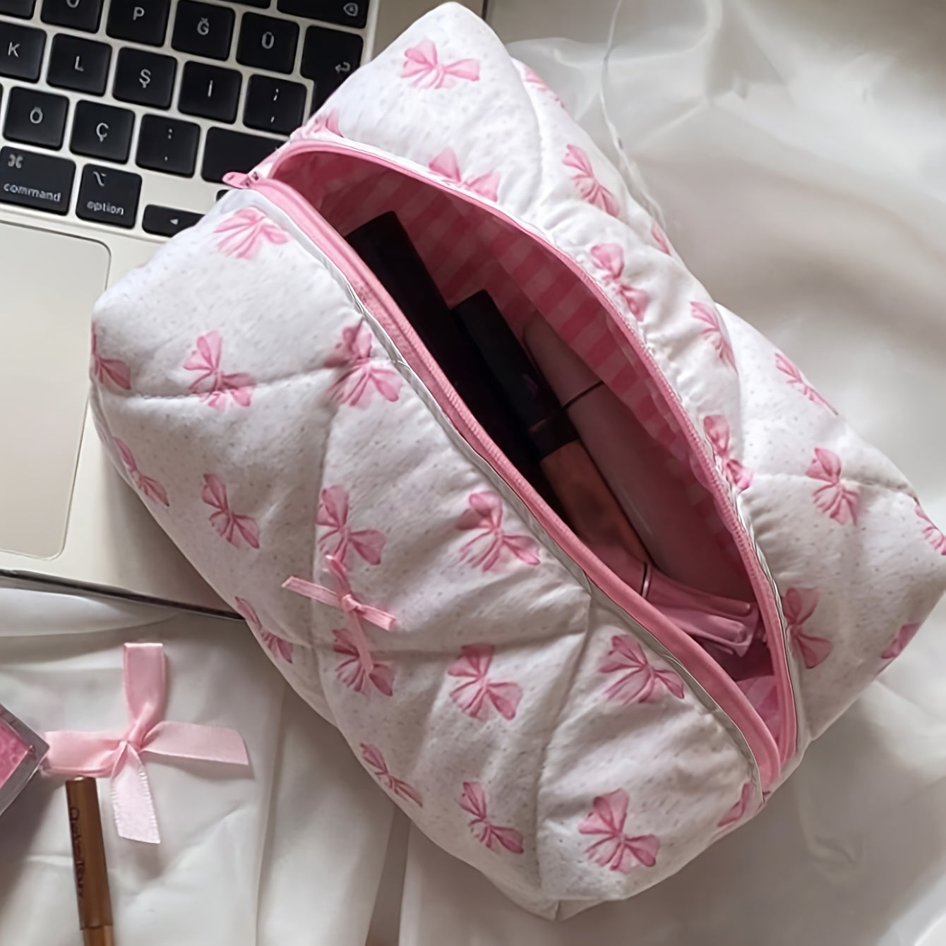 Spacious portable makeup organizer with chic rose print and bowknot detail, made of non-waterproof polyester.