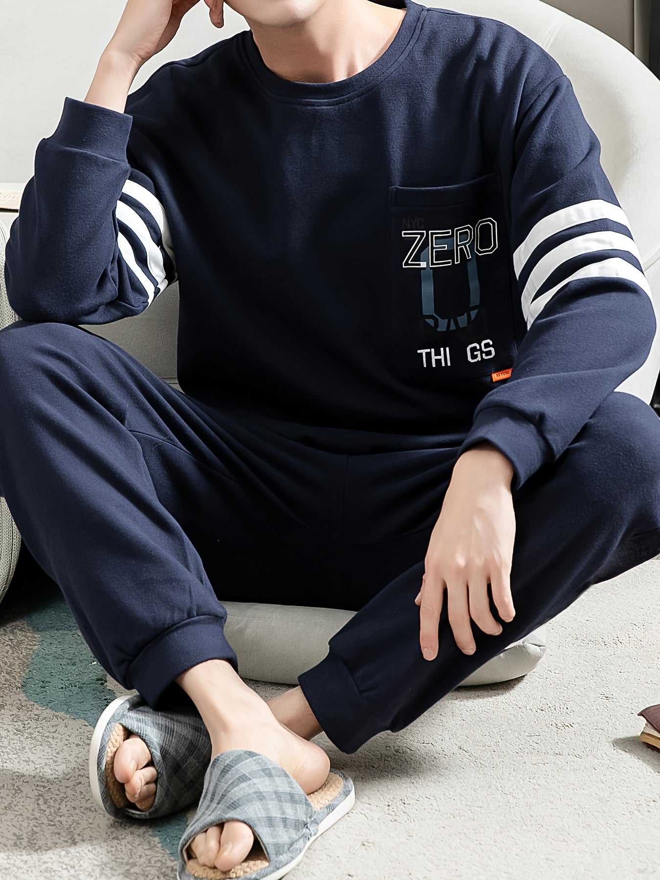 Casual cotton pajamas set for men with letter graphic print, long sleeve crew neck top with chest pocket and loose pants. Suitable for spring and autumn.