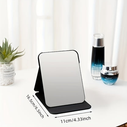 Stylish black foldable makeup mirror, great for desk, bedroom, and bathroom decor. Ideal for travel and makes a unique gift for weddings, parties, and birthdays. Glass surface with polished finish.