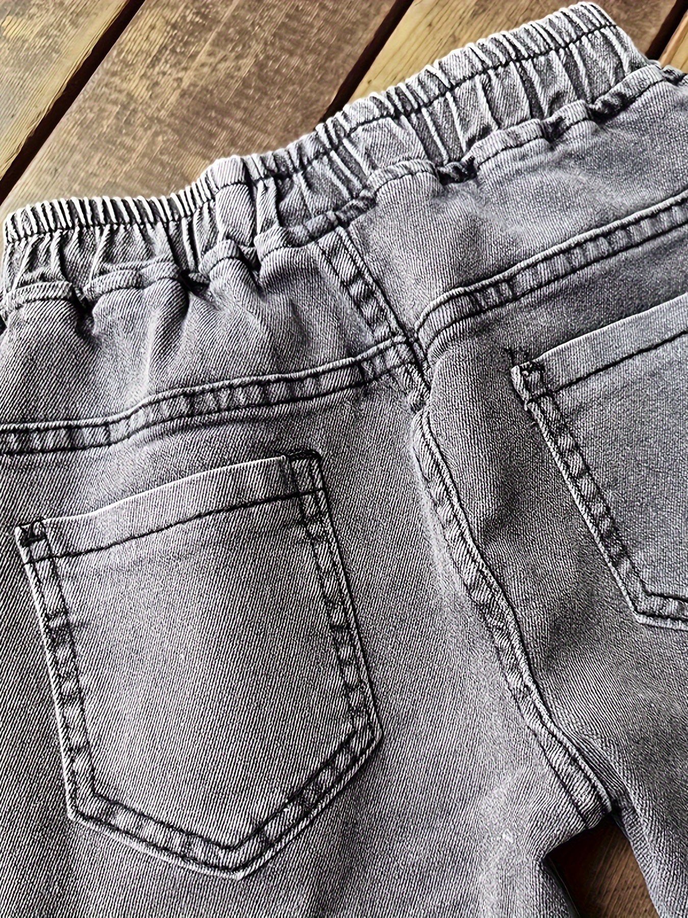 Boys' versatile denim pants with patch detailing for all seasons.