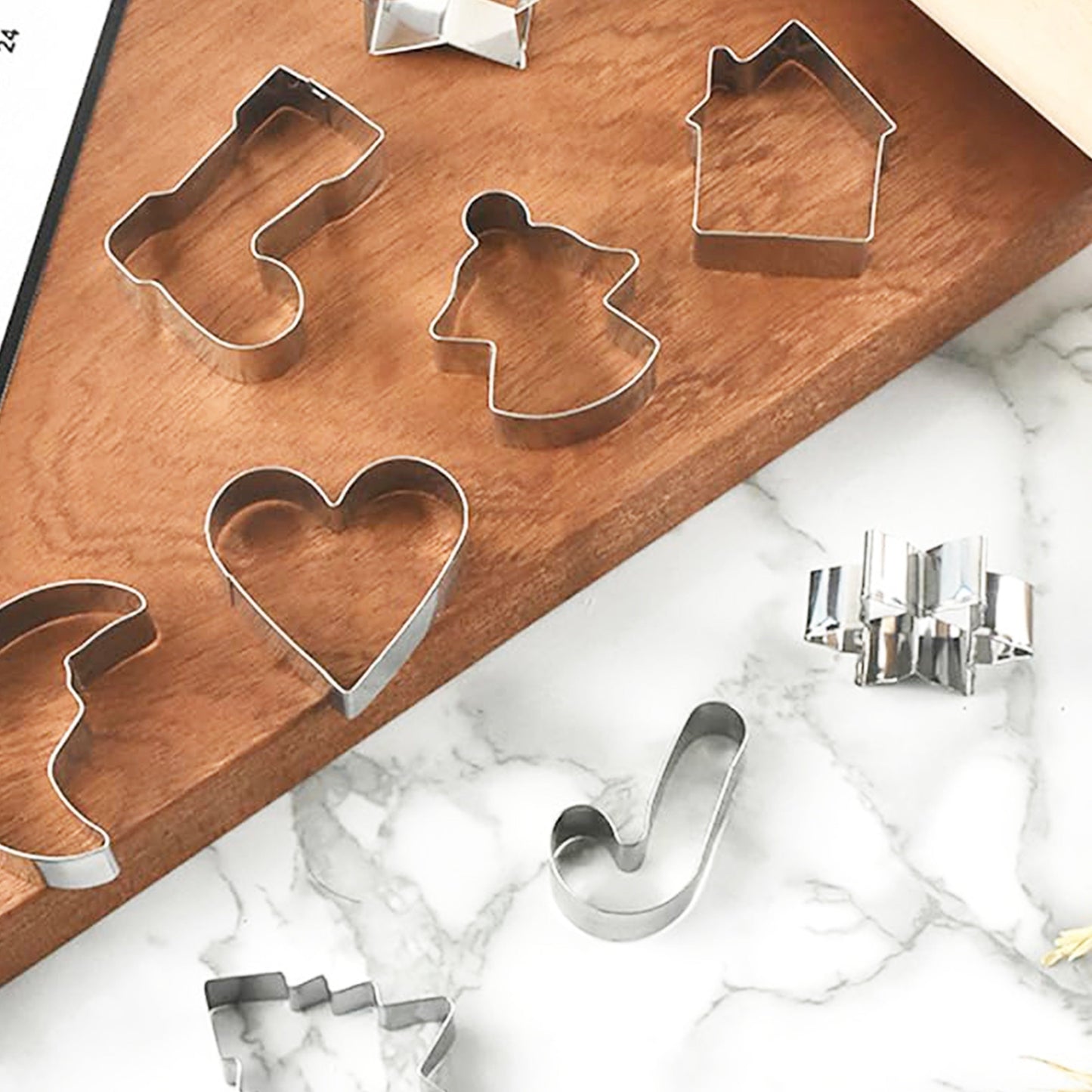 This set of stainless steel cookie cutters and molds has a festive Christmas theme and includes 10 shapes: bell, snowflake, Christmas stocking, crutch, Christmas tree, heart, star, house, moon, and angel.