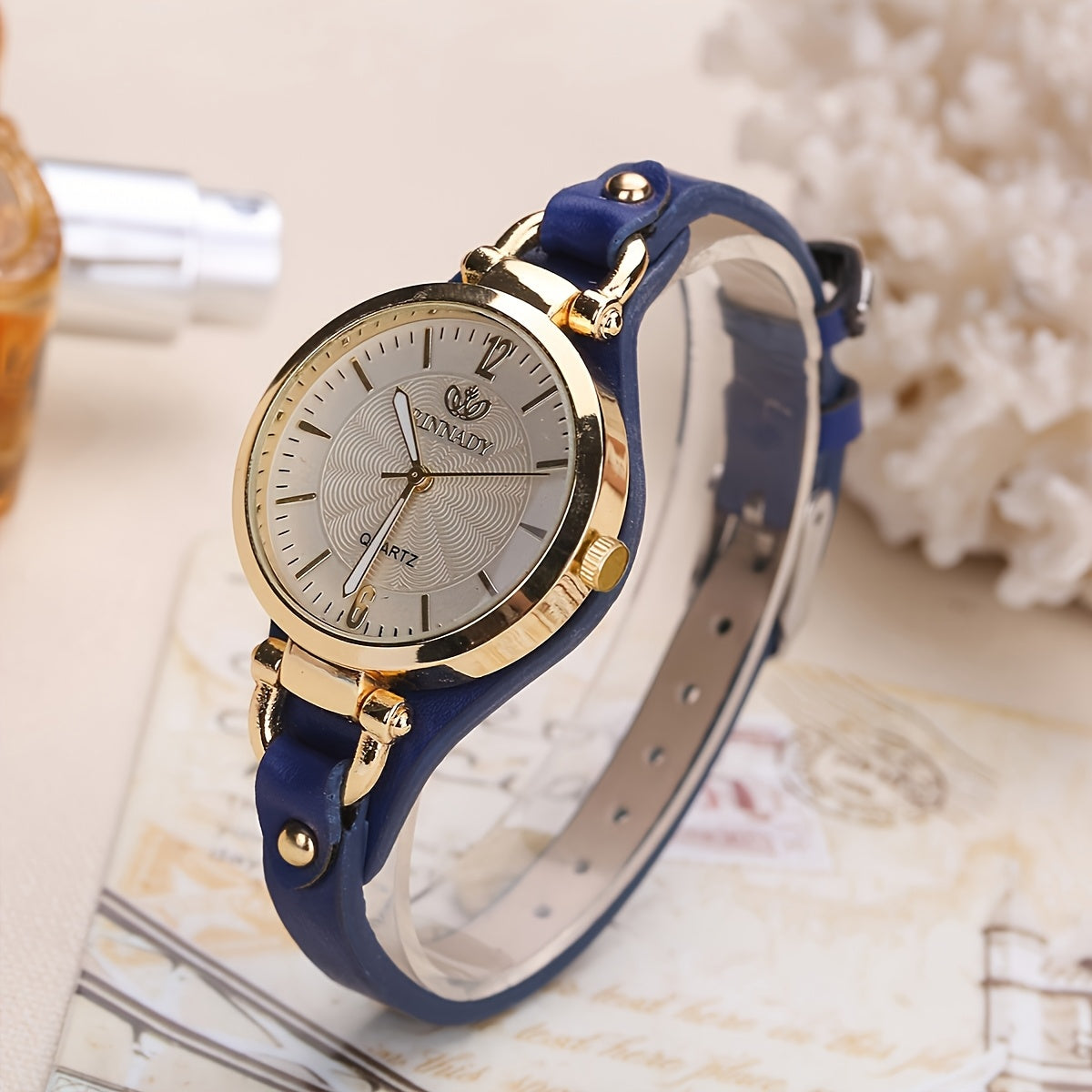 1 elegant women's quartz watch with black faux leather strap and golden-tone accents - fashionable analog display, battery operated, perfect for everyday and special occasions.