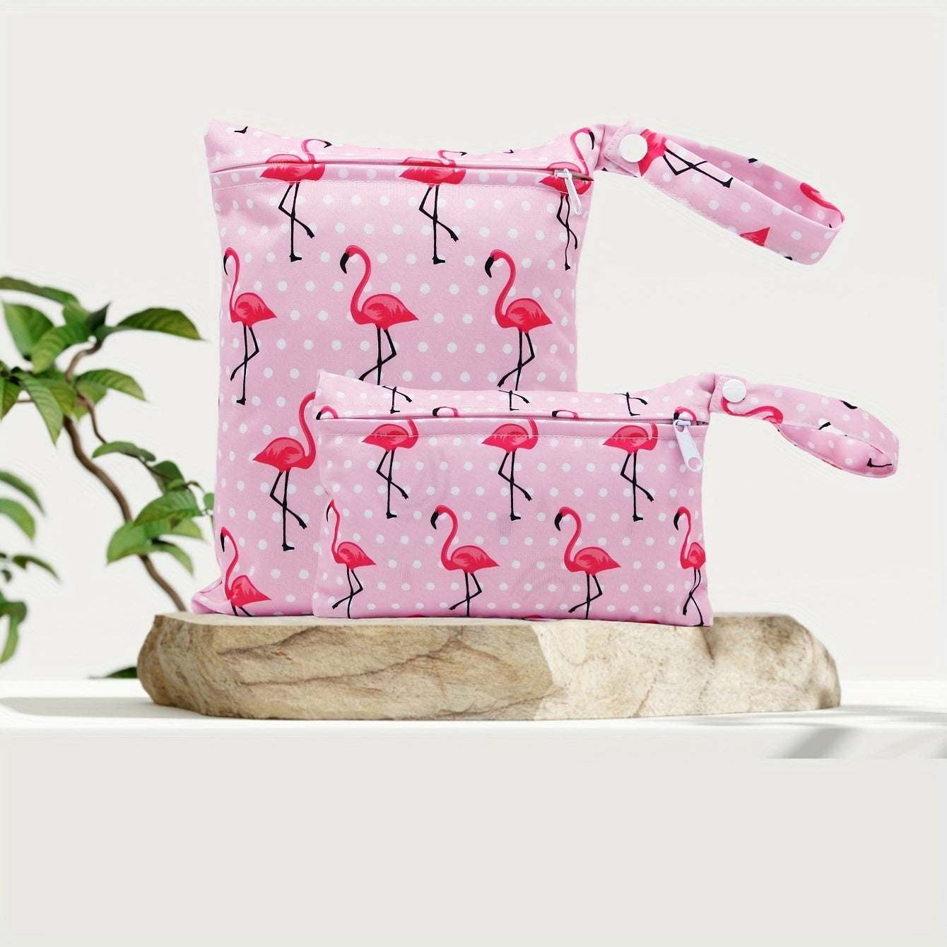 The Asenappy Set of 2 Wet Dry Bags features a trendy Flamingo Print design. These waterproof reusable bags are perfect for storing diapers and laundry but can also be used as a travel organizer for swimsuits, cosmetics, toys, and more. Suitable for ages