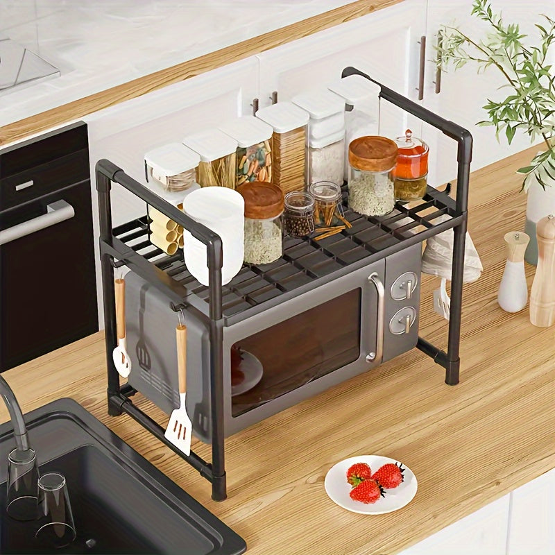 The Expandable Double-Layer Microwave Rack with Classic Style features 4 Hooks for added convenience. This Multi-functional Kitchen Storage Organizer is constructed with Metal and Plastic materials. Assembly is required, but no batteries are needed.