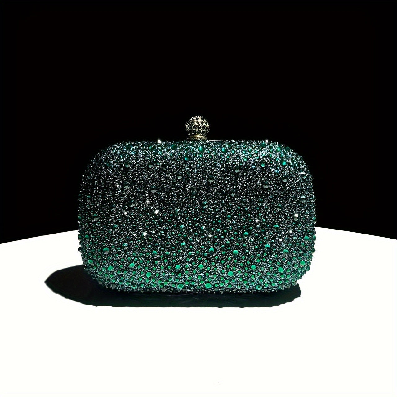 Stylish emerald green handbag with golden chain, suitable for formal events and as a gift for women.