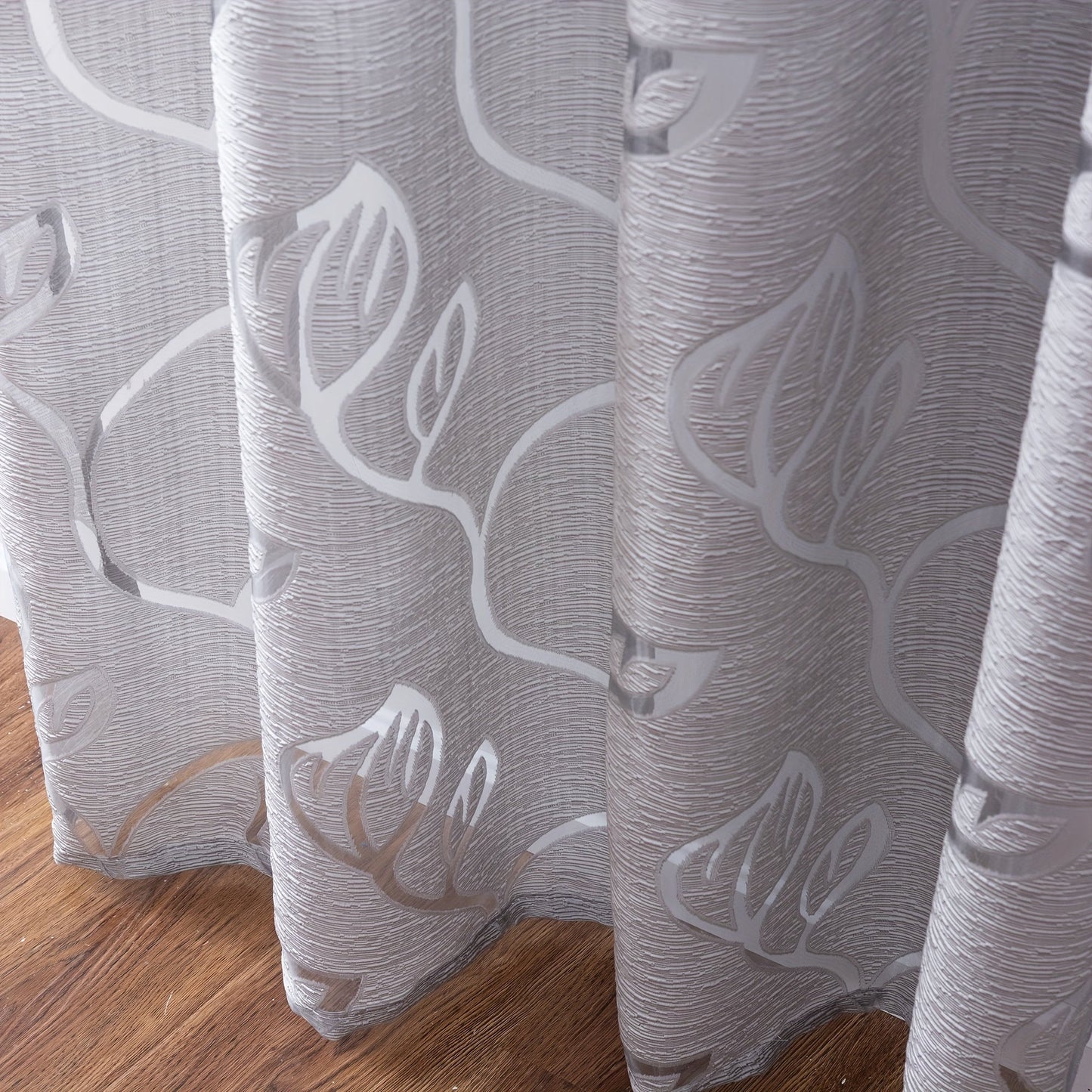 Elegant and contemporary gray floral sheer curtain with a rod pocket design, perfect for enhancing the decor of your living room, bedroom, or home.