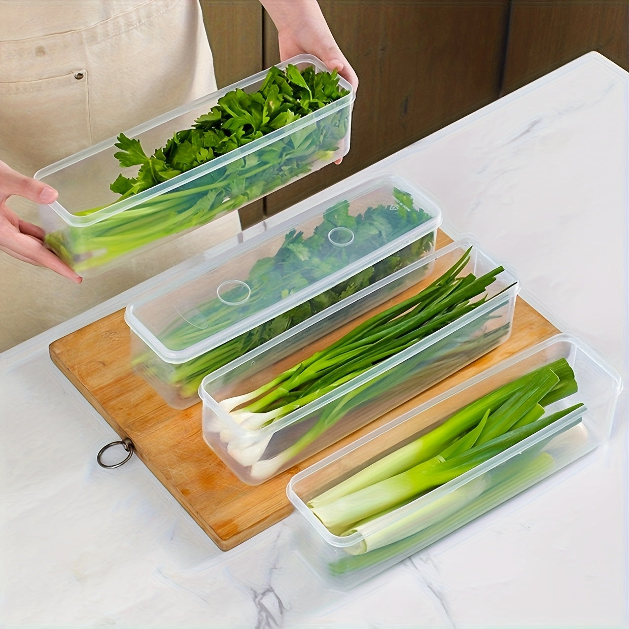 Set of 4 rectangular food storage containers with lids, made of reusable plastic for organizing onions, parsley, cilantro, garlic, pasta, and eggs in the refrigerator. These kitchen essentials are perfect for hand washing and organizing your pantry.