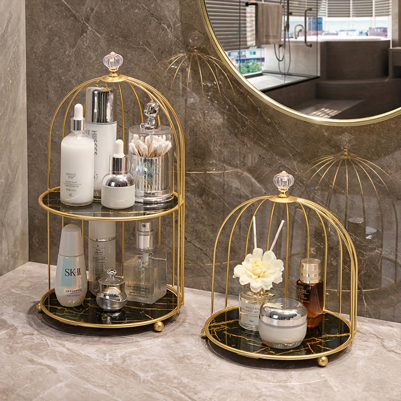 Luxury gold-toned cast iron makeup organizer with cage-shaped bathroom shelf for elegant display of perfumes and skincare products on vanity or countertop.