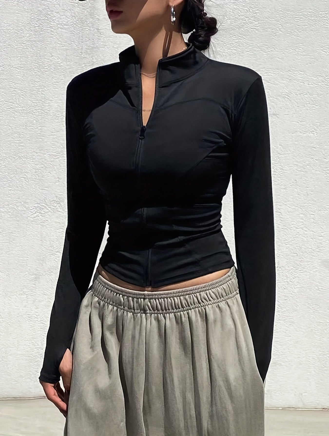 Slim fit, long sleeve mock neck top with solid zipper front for women in spring and fall.