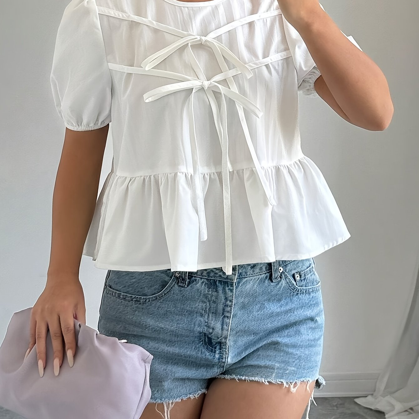 Puff-sleeve shirt with ruffles and front bow tie.