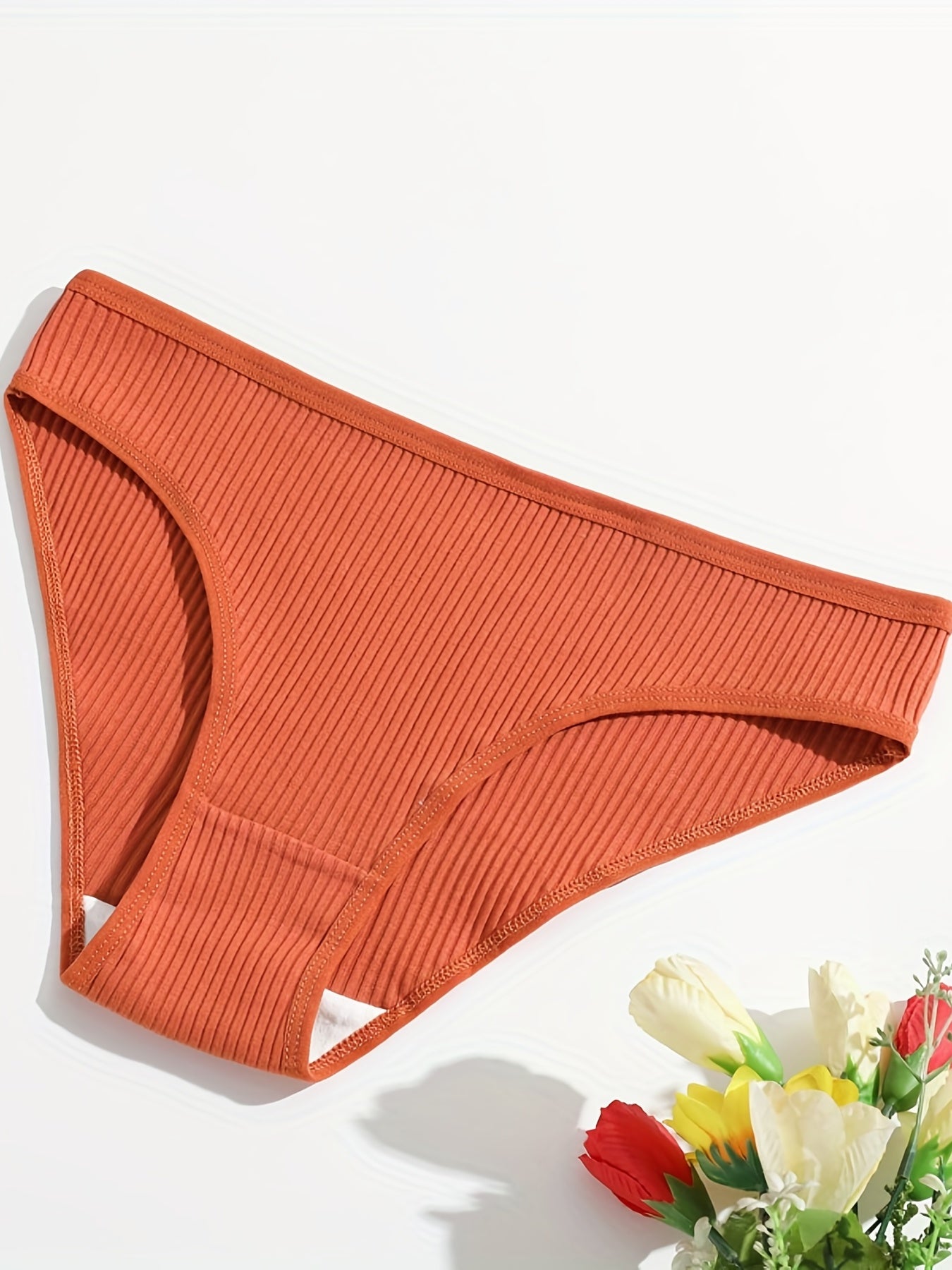 5 comfortable women's briefs with butt lift, low-rise, breathable, double-layered, available in red, gray, teal, orange, and black solid colors. Made of soft ribbed stretch material.