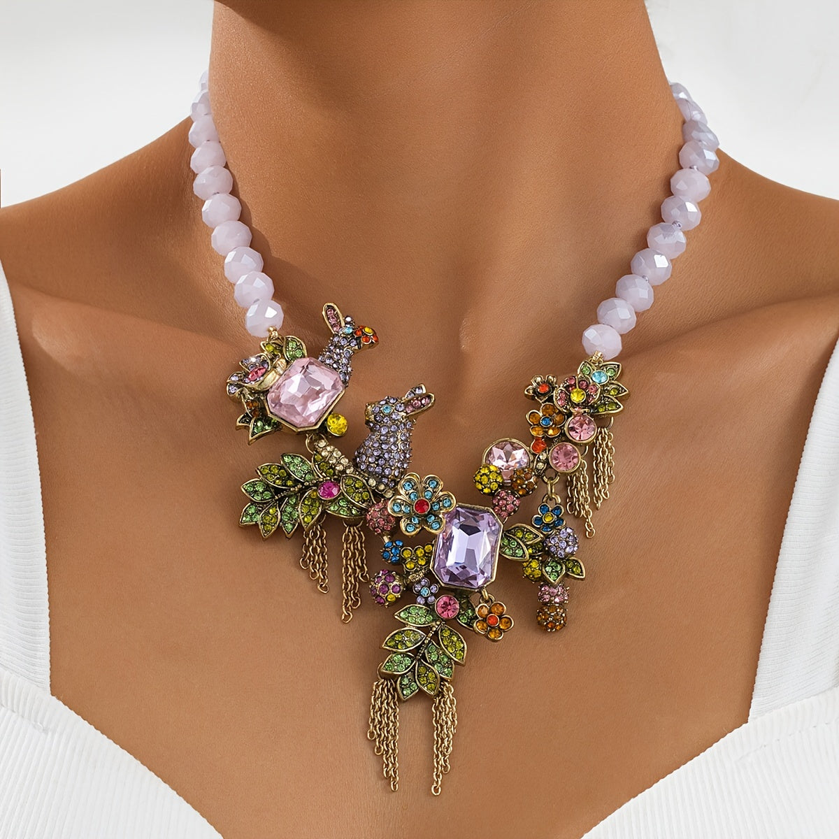 Necklace featuring an ornate vintage-style rabbit pendant with rhinestone tassels, glass crystals, and leaf accents.