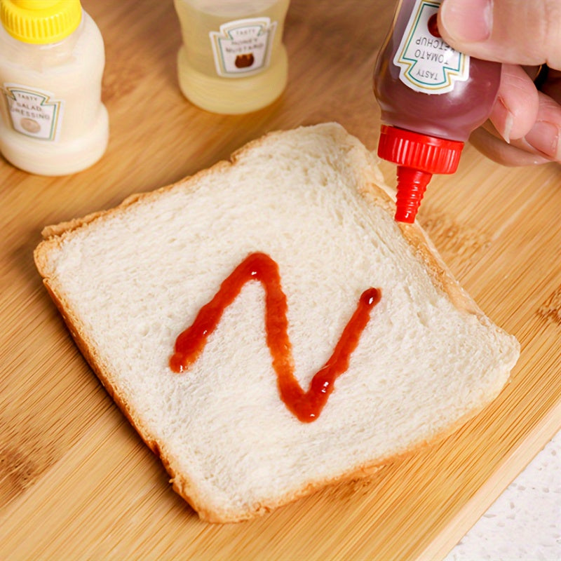 Set of 4 mini sauce bottles for condiments and spices, ideal for lunches, picnics, and kitchen use.