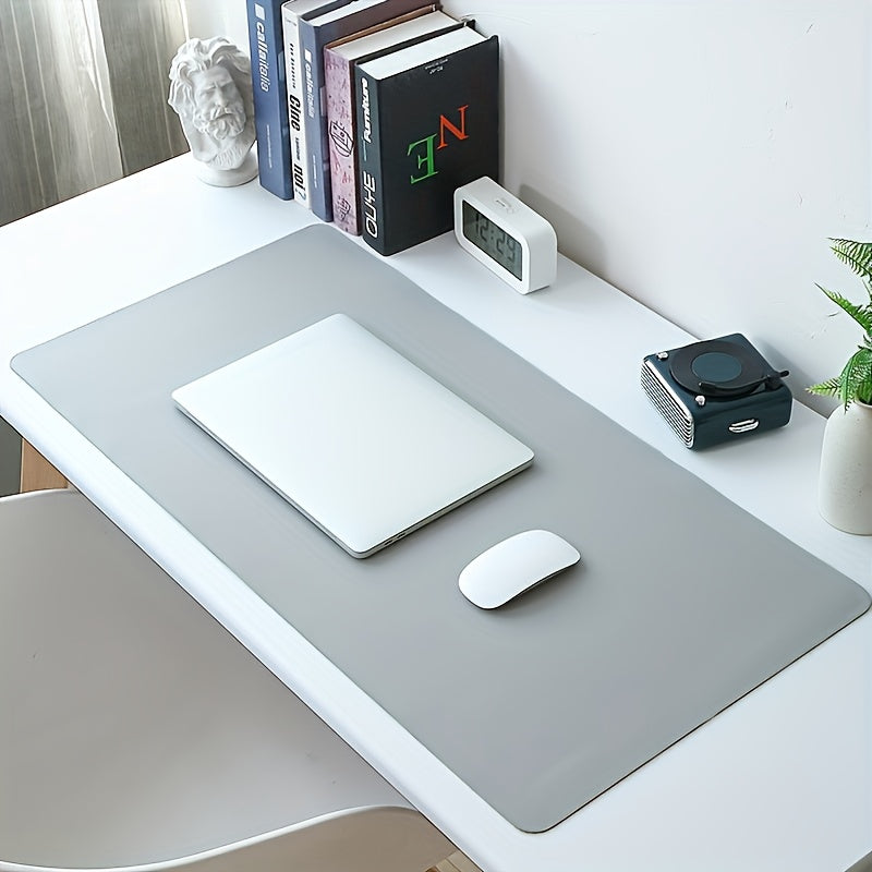 Waterproof faux leather desk pad with anti-slip surface for office and home use. Measures 59.99 x 32.99 cm. Rectangular mouse pad for workspace protection. Sleek and easy to clean design.