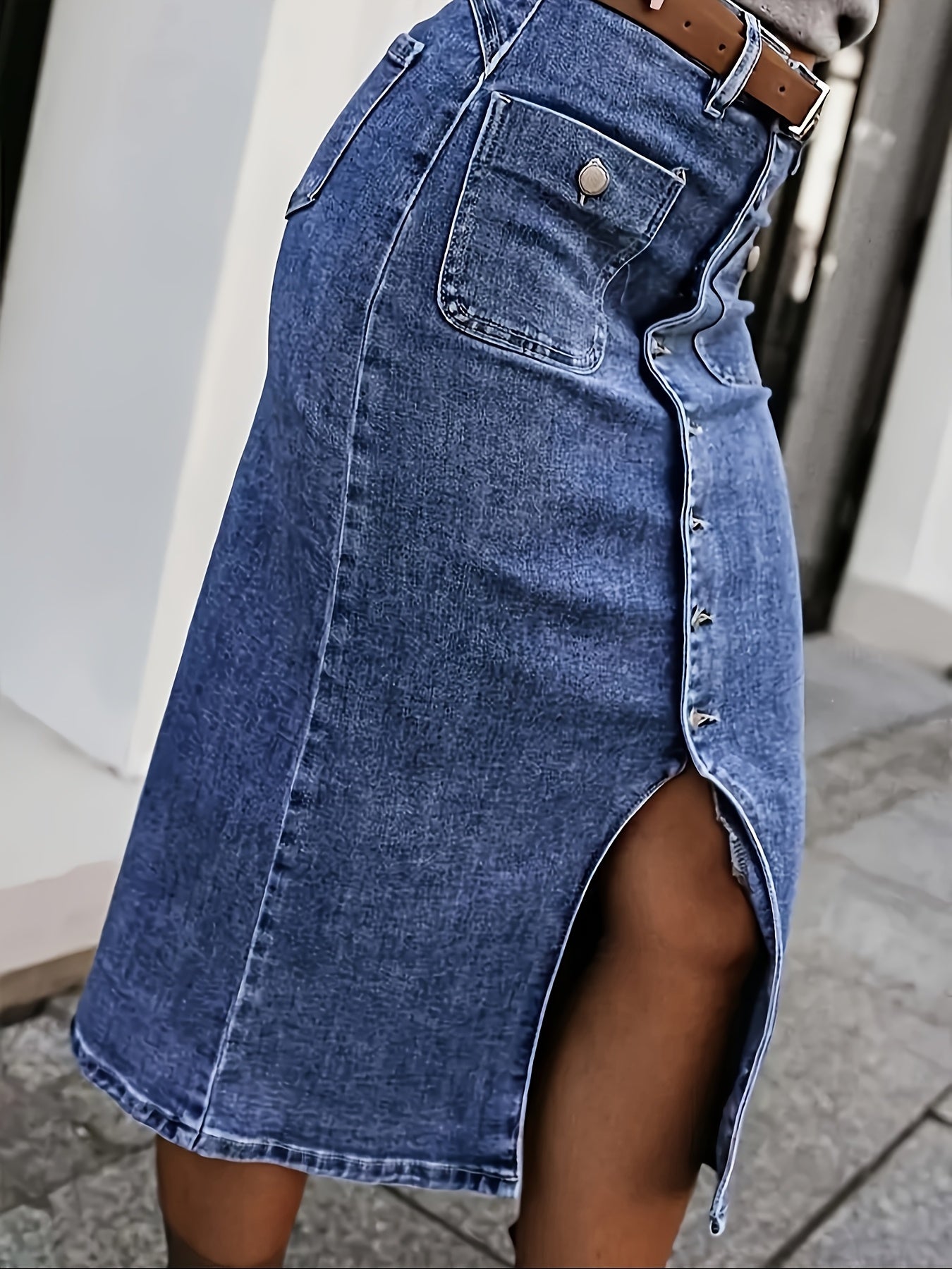 Women's washed blue denim skirt with front buttons, side slit, and casual stretch denim. Ideal for autumn casual outfits.