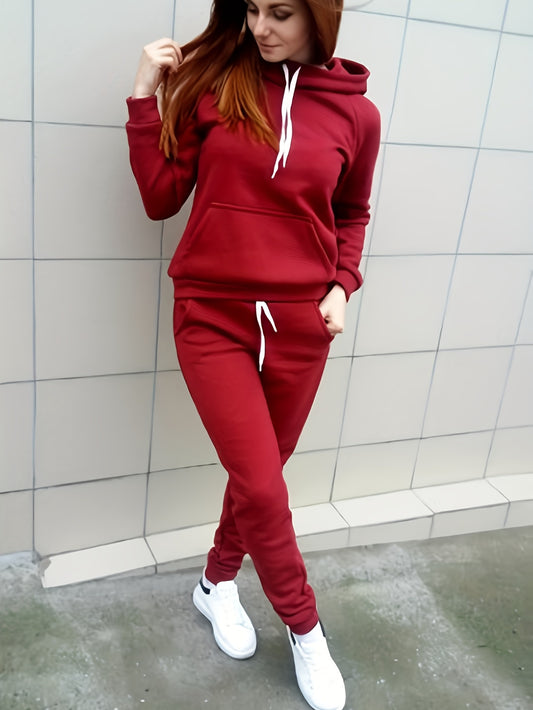 Women's polyester hooded sweatshirt and pants set with solid color long sleeve pullover, pocket detail, 100% polyester knit fabric. Ideal for fall/winter sportswear.