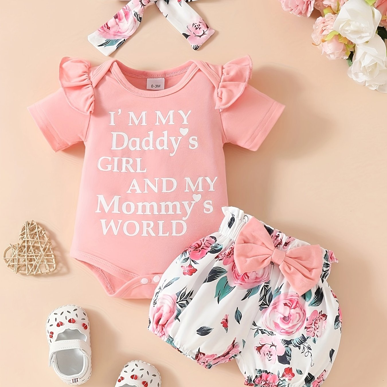 Cute 3-piece girls' outfit set with 'Daddy's Girl, Mommy's World' letter print romper, floral shorts, and matching headband. Made of soft polyester blend, ideal for summer and outdoor wear.