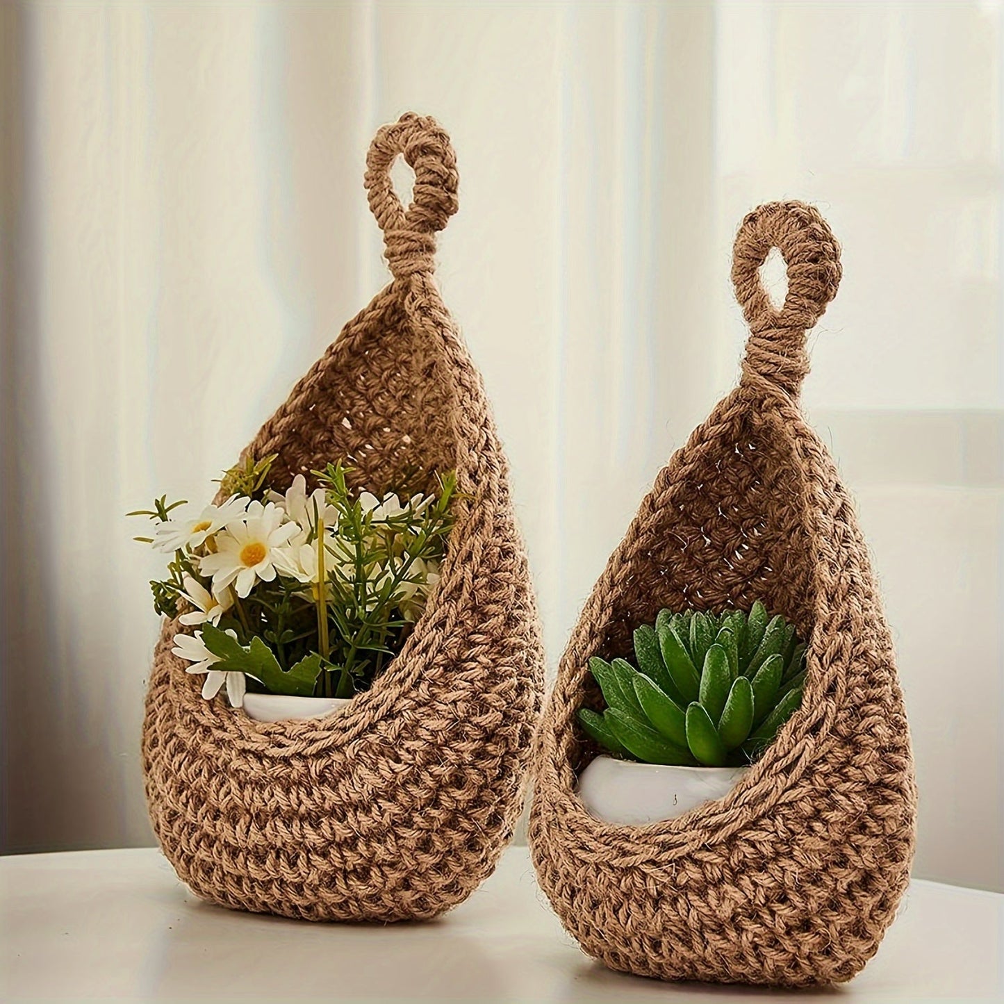 Set of 3 hanging baskets made of cotton rope and sisal crochet, featuring water drops design. This versatile storage solution can be used as a fruit, vegetable, or plant holder, or as a kitchen organizer. Hang them on the wall to save space and add a