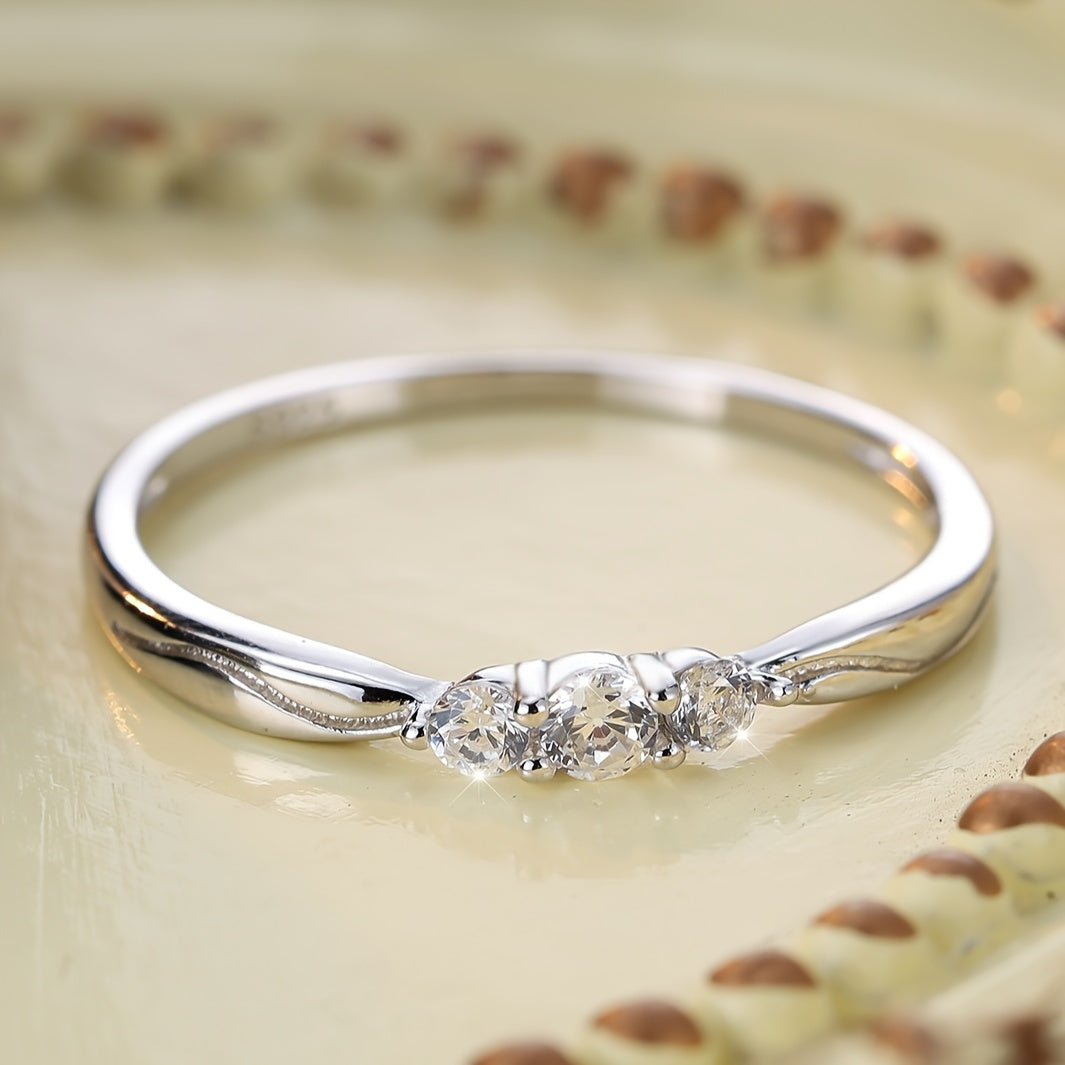 This elegant and adaptable sterling silver ring features three delicate white zircons, perfect for weddings or as a lovely gift for a mother. Weighing 1.4g, this ring is a timeless piece that can be worn on any occasion.